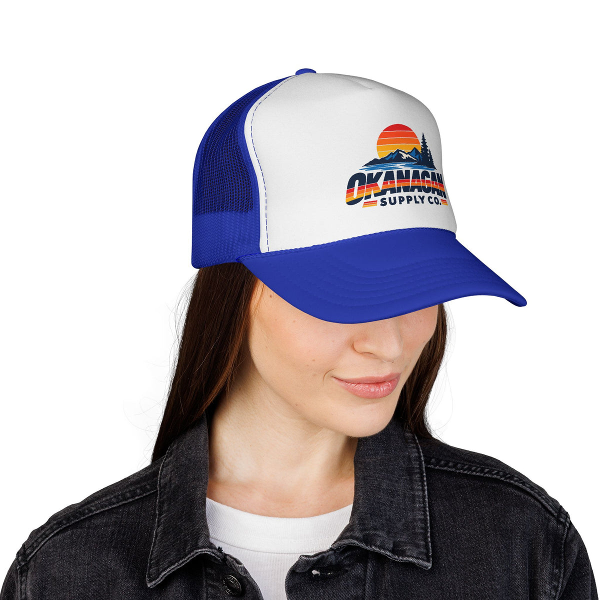 Okanagan Supply Co. Vintage Outdoors trucker hat in royal blue, worn by a model
