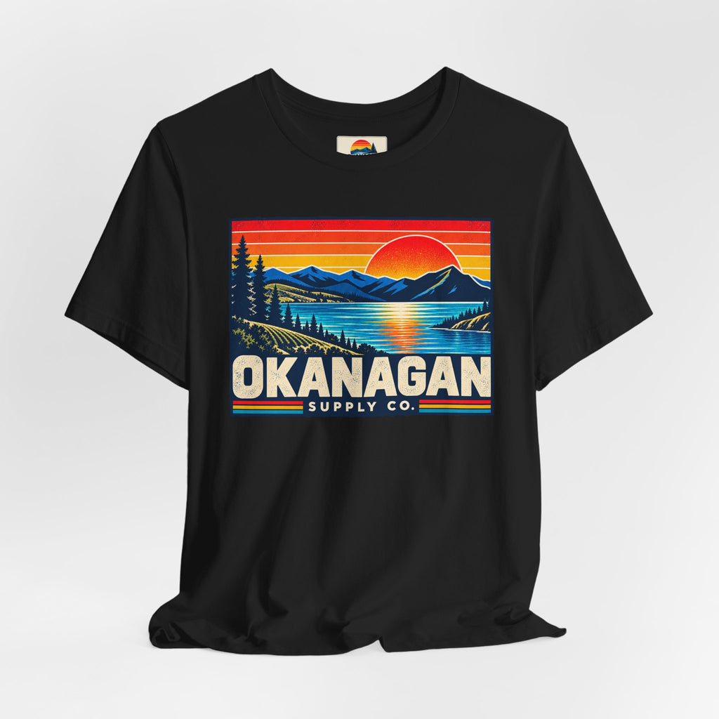 Okanagan Supply Co. Retro Sunset Tee in black, styled flat view with sunset badge
