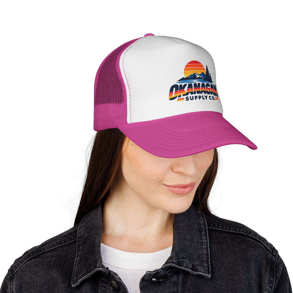 Okanagan Supply Co. Vintage Outdoors trucker hat in pink, worn by a model
