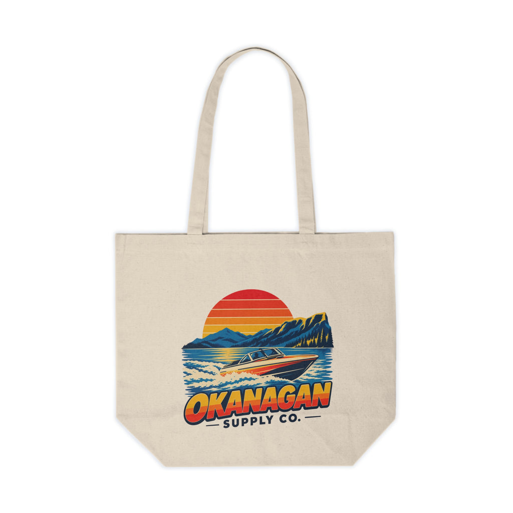 Okanagan Supply Co. Lake Day Speedboat Canvas Tote in natural, front view with the retro speedboat and sunset print