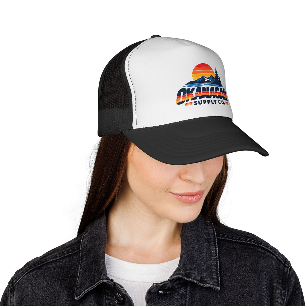 Okanagan Supply Co. Vintage Outdoors trucker hat in black, worn by a model