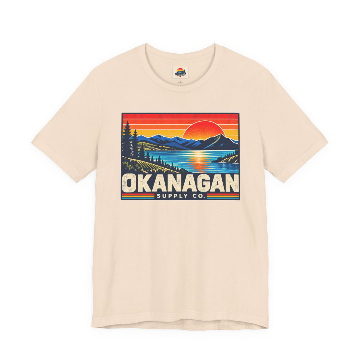 Okanagan Supply Co. Retro Sunset Tee in soft cream, front view with retro Okanagan lake sunset badge