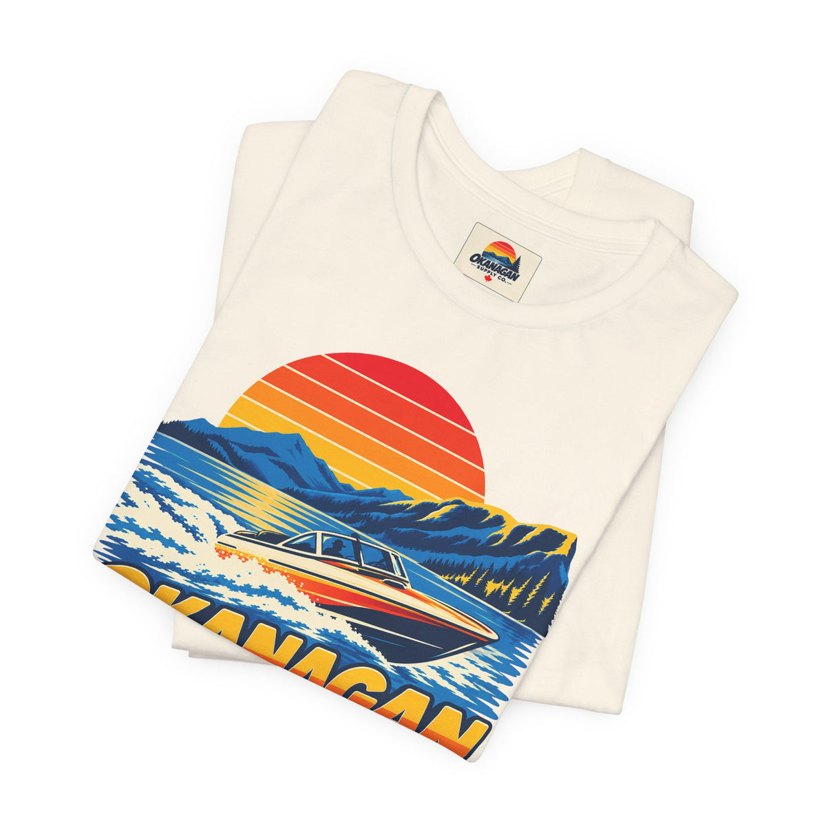 Okanagan Supply Co. Lake Day Speedboat Tee in natural, folded to show the retro speedboat and sunset print and inside collar label