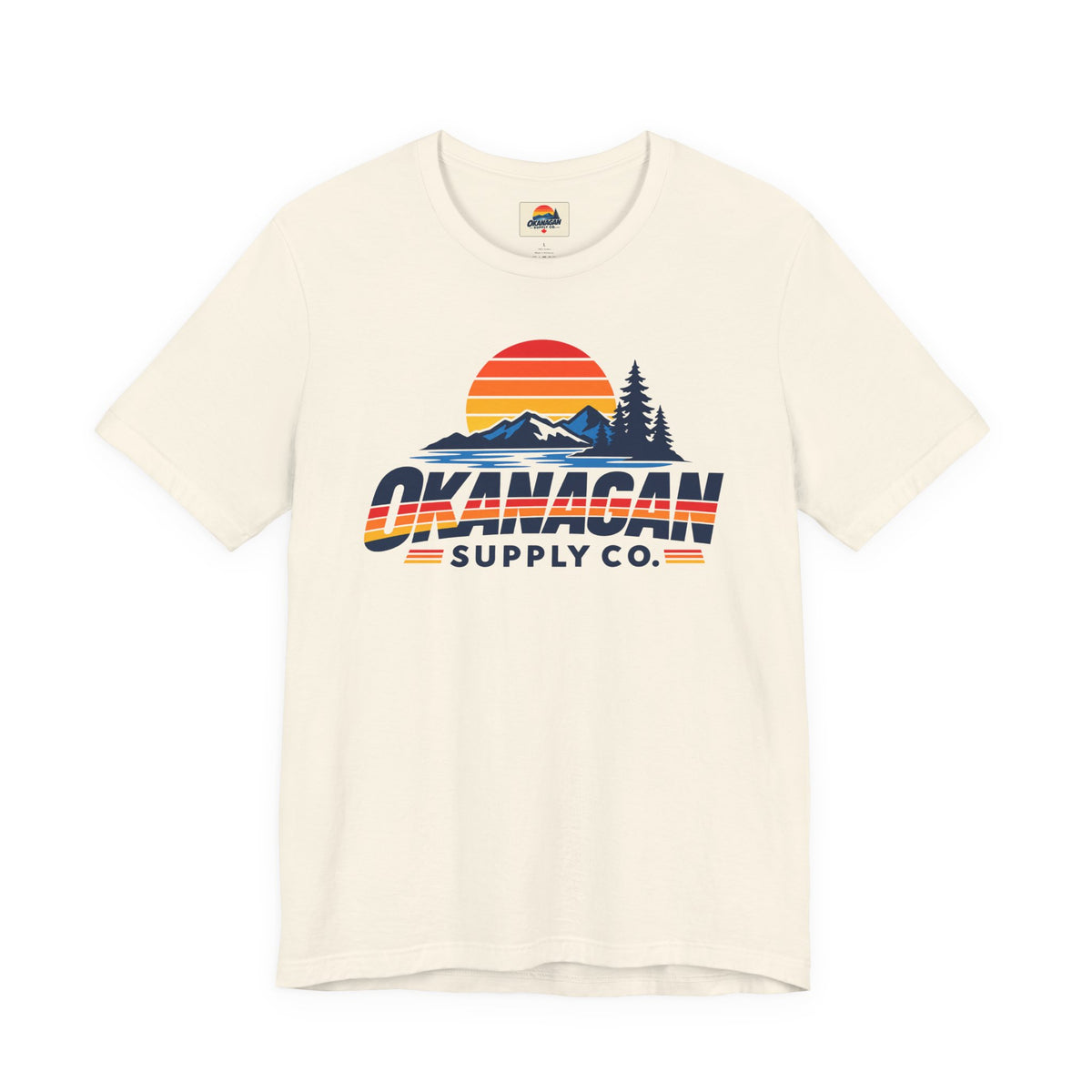 Okanagan Supply Co. Vintage Outdoors Tee in natural, front view with retro sunset, mountain and pine print