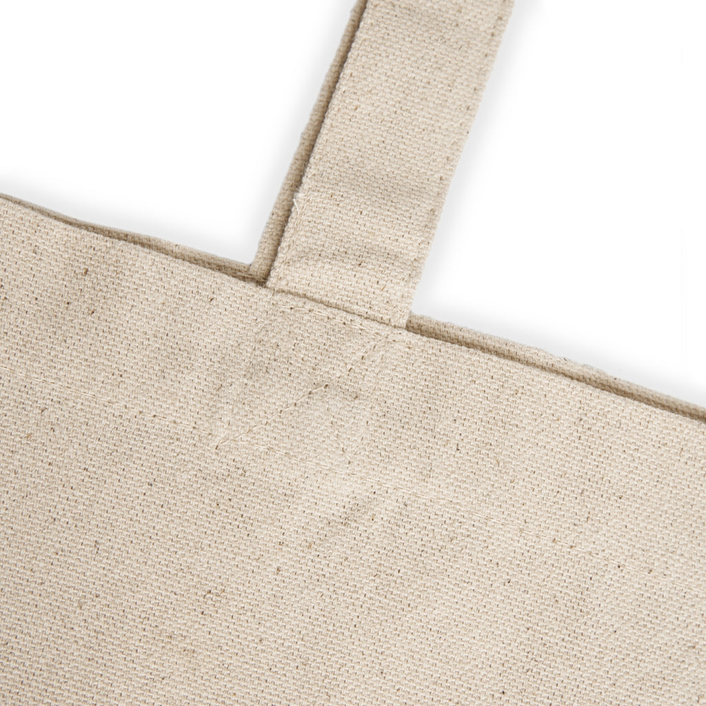 Close-up of the natural cotton canvas and shoulder strap stitching on the Okanagan Supply Co. tote